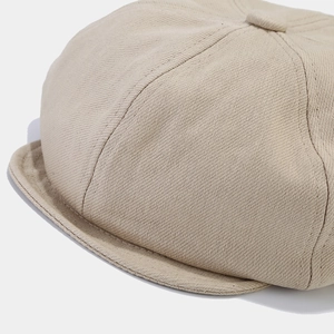 Classic beige twill newsboy cap for women featuring detailed brim stitching and fabric texture
