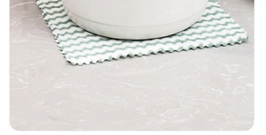 Close-up of green wave pattern coral fleece dishcloth used as a heat-resistant bowl mat