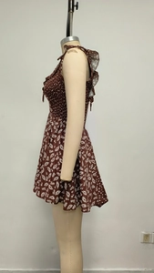 Detail of ruffle straps and elastic shirring on brown daisy print sundress