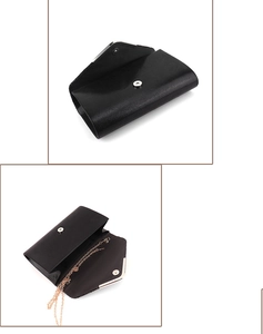 Detail of black fine-textured leather evening clutch with gold chain strap and magnetic closure