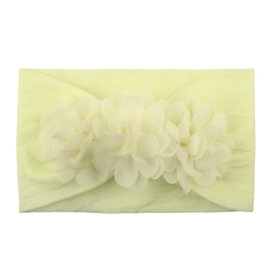 Detail of soft elastic nylon headband with three yellow chiffon flowers for baby girls