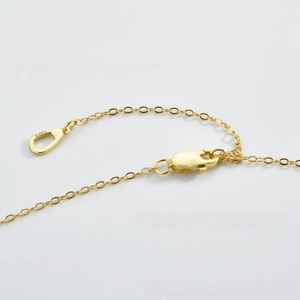 Detail of S925 sterling silver lobster clasp with hallmark tag on a gold necklace