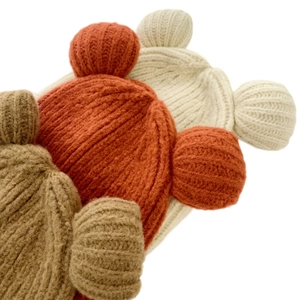 Close-up of knit hats with bear ears in caramel, beige, and khaki for autumn