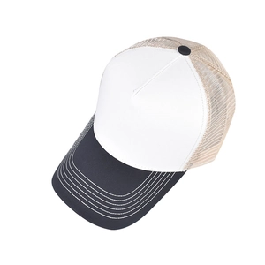 Detail view of two-tone trucker hat with white stitching on black brim and beige mesh back