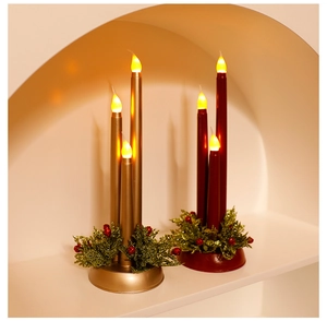 Detail of red and gold LED tapered candles with festive sequined decorative bases