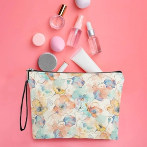 Floral makeup bag with watercolor patterns and black zipper on pink background