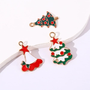 Three Christmas enamel charms including green tree and Santa hat for DIY jewelry making