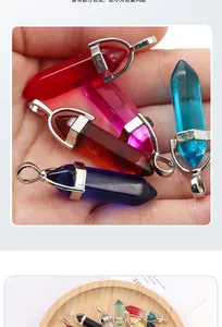 Macro shot of colorful hexagonal crystal pendants displayed on hand and wooden tray