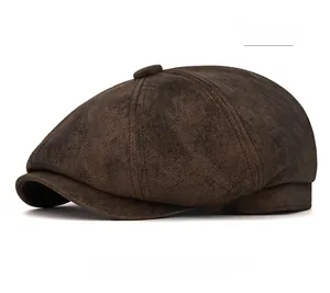 Close-up of brown suede newsboy cap featuring detailed stitching and retro crown
