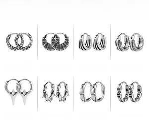 Detail view of eight stainless steel punk hoop earring styles with textured patterns