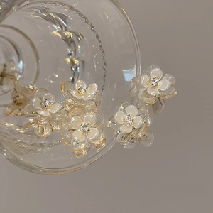 Mini camellia flower hair clips with sparkling rhinestones on transparent glass cup