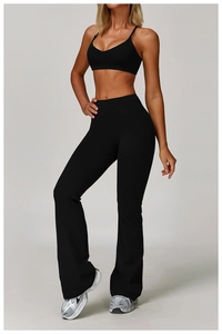 Full view of black deep-V sports bra and high-waist yoga pants on professional model