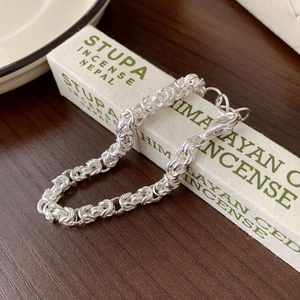 Handcrafted 925 sterling silver geometric chain bracelet on a minimalist incense box