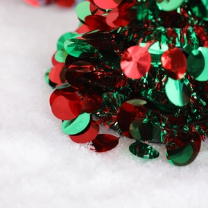 Close-up of red and green sequin ribbons with sparkling tinsel for festive holiday decor