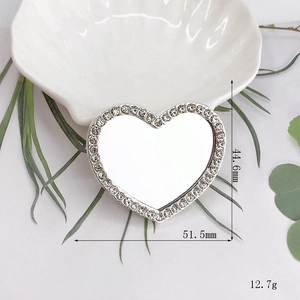 Detail view of heart-shaped rhinestone mirror accessory with 51.5mm x 44.6mm dimensions