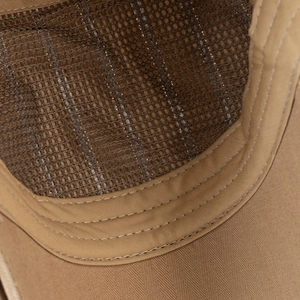Detailed macro view of breathable mesh and twill stitching on a khaki beret hat