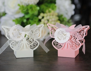 Detail of pink and white hollow butterfly gift boxes with Thank You tags and ribbons