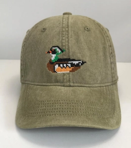 Close-up of duck embroidery on vintage olive green cotton baseball cap showing stitching