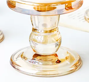Close-up of amber Roman column glass candle holder with warm golden vintage texture