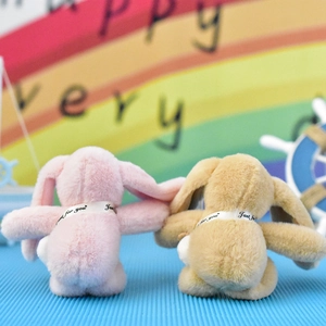 Back view detail of two cute plush bunny doll pendants in soft pink and tan plush colors.