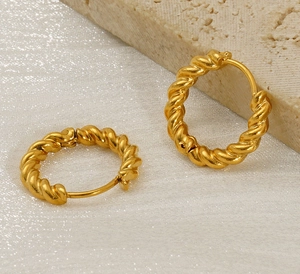 Detailed macro view of gold-plated stainless steel twisted rope hoop earrings