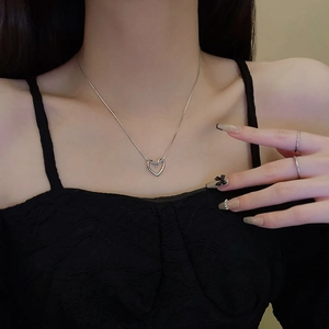 Minimalist silver heart pendant necklace in titanium steel worn by a model
