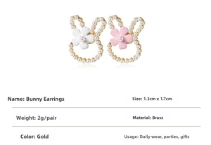 Detailed view of rabbit shaped earrings with faux pearls and brass gold finish