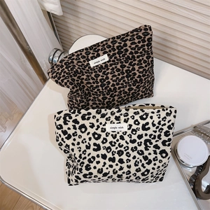 Detailed view of leopard print canvas makeup bags with zippers and simple wish labels