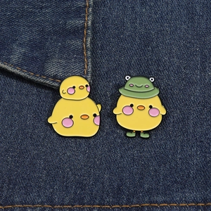 Cute cartoon yellow duck enamel pins on denim fabric, set of two animal metal brooches
