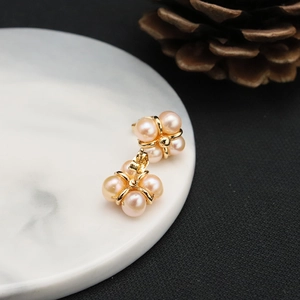 Elegant natural freshwater pearl stud earrings with gold base in a floral cluster design