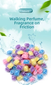 Macro shot of colorful scented laundry beads in transparent pouches with clean water splash