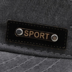 Washed cotton baseball cap in dark grey featuring a leather Sport patch with silver rivets