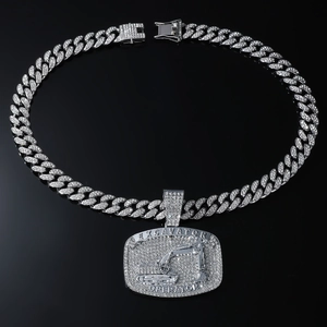 Macro shot of silver Cuban chain with diamond-encrusted excavator operator pendant