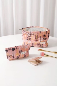 Detailed embroidery on a two-piece floral cotton cosmetic bag set with zipper closures