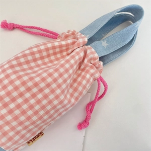Close-up of pink plaid water bottle bag with star pattern handle and drawstring