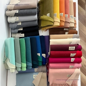 Multiple rows of colorful double-sided cashmere-like scarves with fringe details