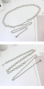 Detail of silver metal chain belt with polished circular rings and lobster clasp closure