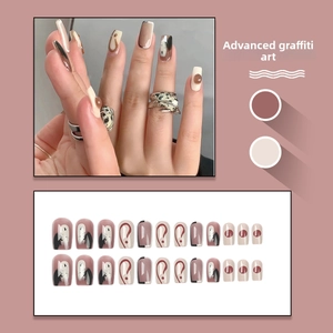 Artistic graffiti press-on nails set featuring neutral tones in medium square oval shape