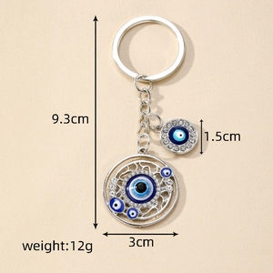 Macro shot of Evil Eye keychain with blue rhinestones and size dimensions shown