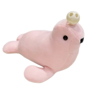 Soft pink seal plush toy with a cute white skull bead accessory on a white background