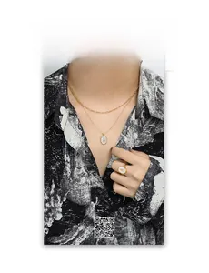 Detail of gold layered tulip necklace and shell ring with flower motif on a model