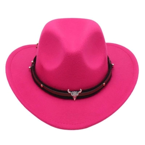 Detail of rose red cowboy hat with bull skull metal emblem and studded bands