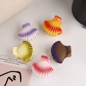 Set of five colorful shell hair clips with gradient matte finish on a minimalist background