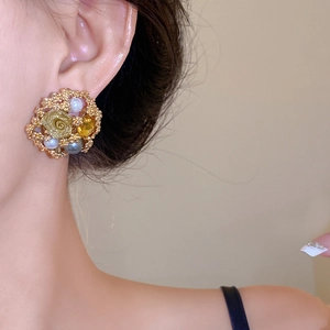 Vintage flower earrings with gold roses, pearls and amber stones on model ear
