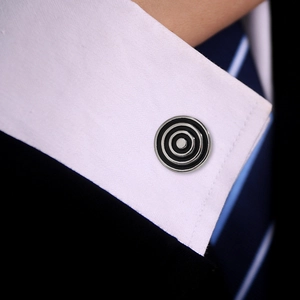 Close-up of classic round black enamel silver cufflinks on a white shirt and blue suit