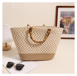 Detail of woven tote bag featuring geometric pattern and vintage bamboo handles