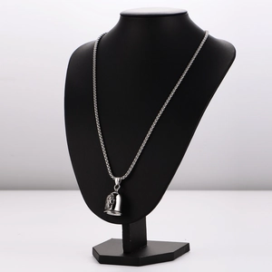 Detailed view of silver stainless steel bell pendant with ethnic Indian chief relief