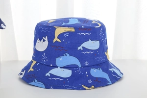 Detailed close-up of a blue canvas kids bucket hat with colorful whale patterns