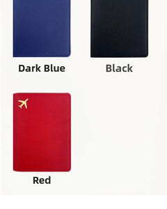 Leather passport covers in navy blue, black, and red with gold airplane charms