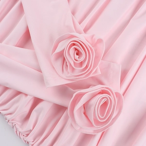 Detailed view of handmade 3D fabric rose petals on an elegant light pink fitted dress